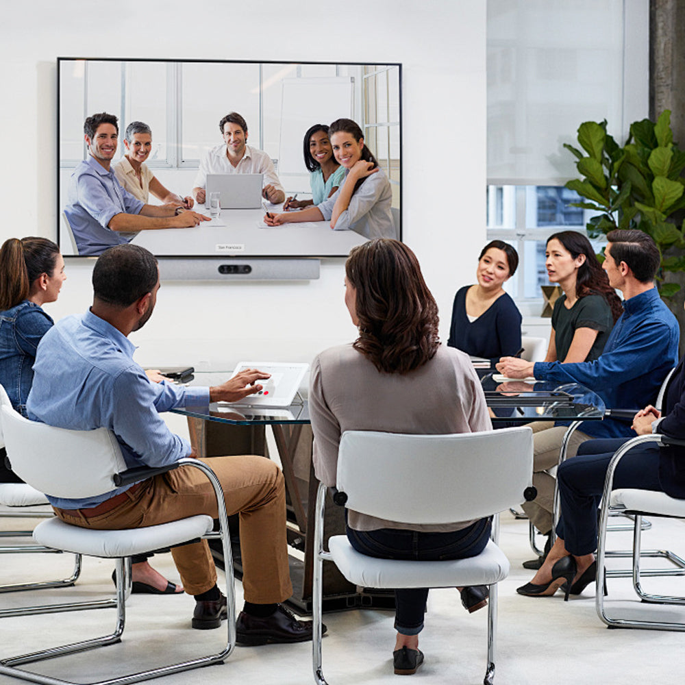 Group of people in a video conference meeting in a modern office setting.